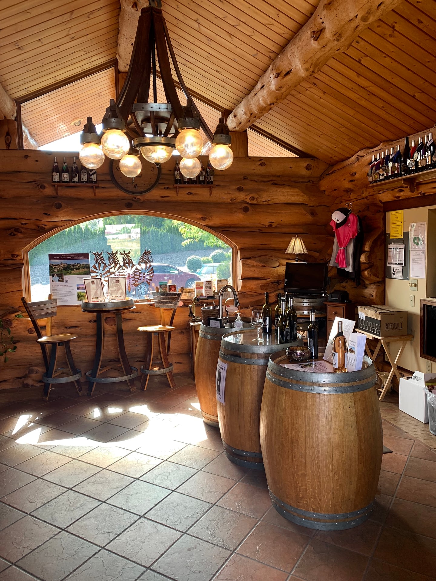 Gorgeous rustic interior with wine barrel tables of Zerba Cellars